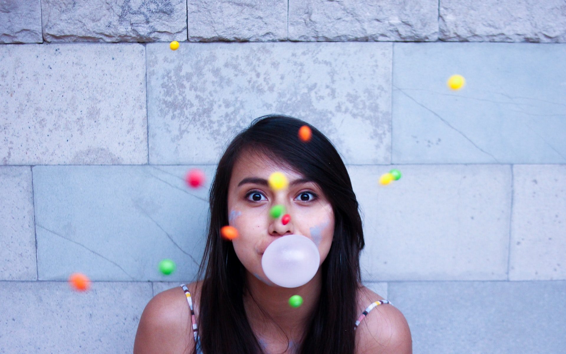 time lapse photo of woman making gum bubble