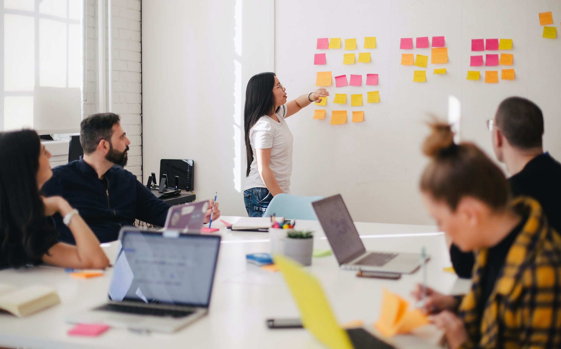 woman placing sticky notes on wall