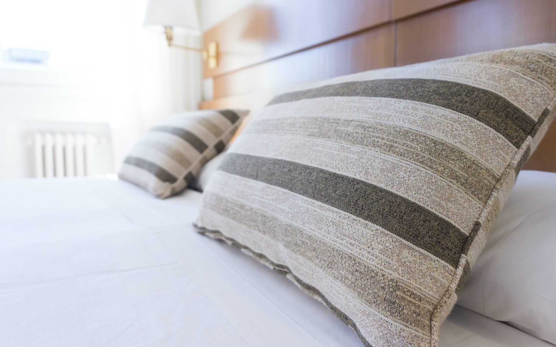 gray and black throw pillow on bed